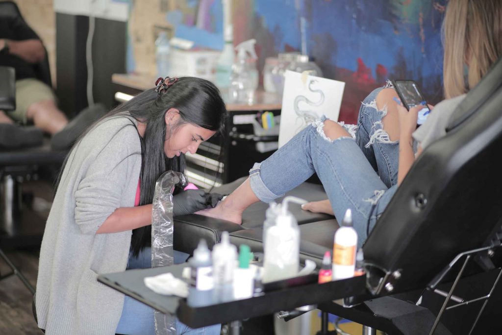 Tattoo artist working