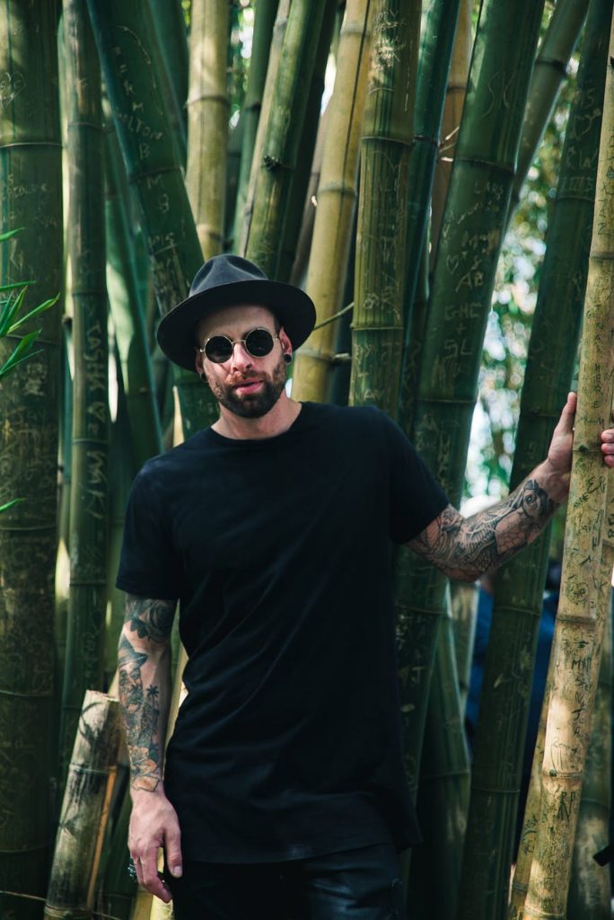 Man with tattoos standing outside