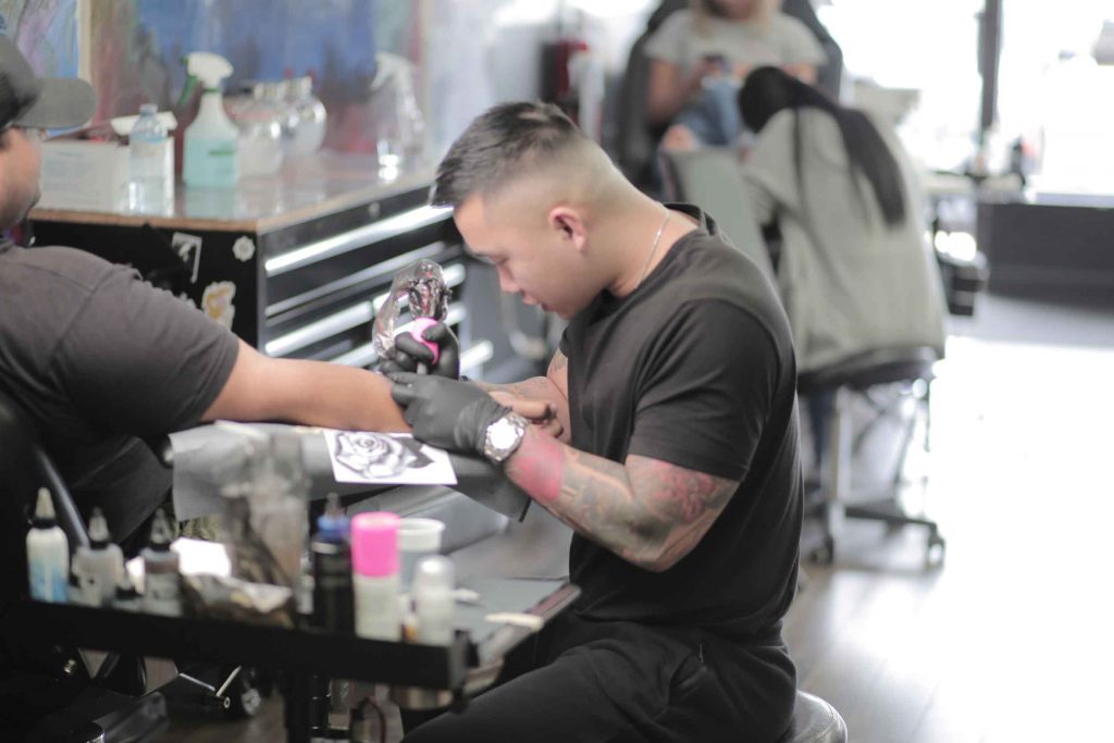 Matthew tattooing a client