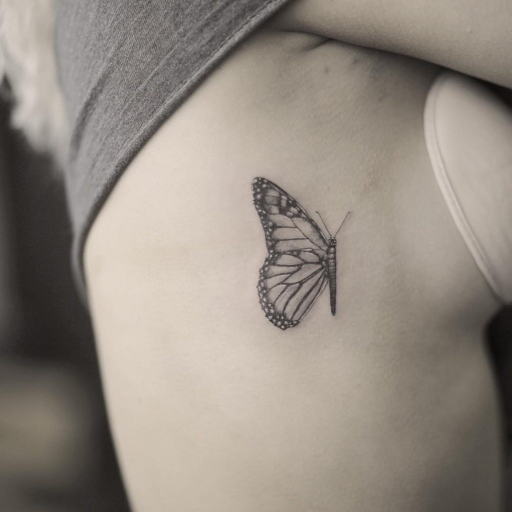 Realistic butterfly tattoo on ribs