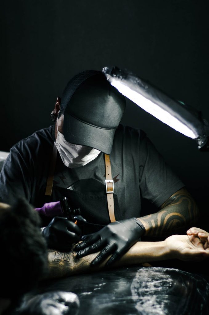 Man getting tattooed with tattoo machine